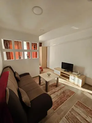 a living room with a couch and a tv at Apartman Annie in Bihać