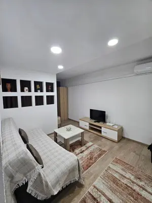 a bedroom with a bed and a tv and a table at Apartman Annie in Bihać