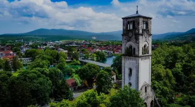 a church tower with a town in the background at Apartman Annie in Bihać