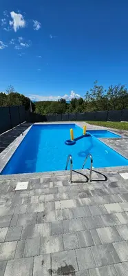 a large blue swimming pool with two water slides at Villa Vienna in Bužim