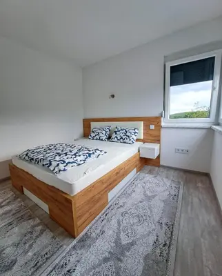 a bedroom with a large bed and a window at Villa Vienna in Bužim