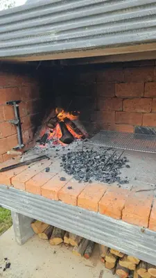 a brick oven with a fire inside of it at Villa Vienna in Bužim
