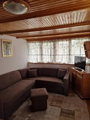 a living room with a couch and a window at Apartman NERA in Ivišovo Greblje
