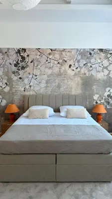 a bedroom with a large bed with two lamps at Apartman Dar in Bihać