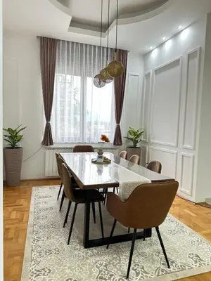 a dining room with a glass table and chairs at Apartman Dar in Bihać