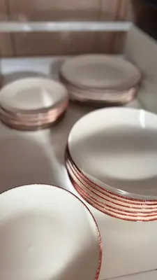 a group of white plates sitting on a stove at Apartman Dar in Bihać