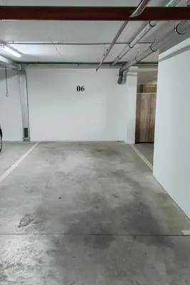 an empty parking garage with a white wall at Apartman VIP in Modriča