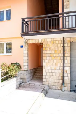 a building with a balcony on top of it at Apartman 11 in Tomislavgrad