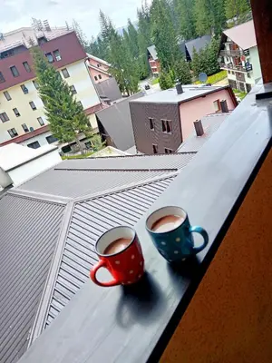 two cups of coffee sitting on a window sill at Apartman EN in Travnik