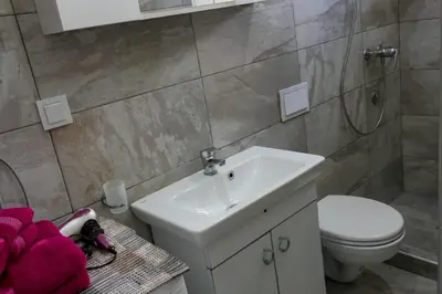 a bathroom with a white sink and a toilet at Villa Plavno in Otoka