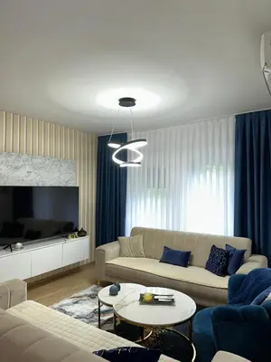 a living room with a couch and a tv at Stan Tesanj in Tešanj