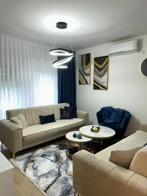 a living room with two couches and a table at Stan Tesanj in Tešanj