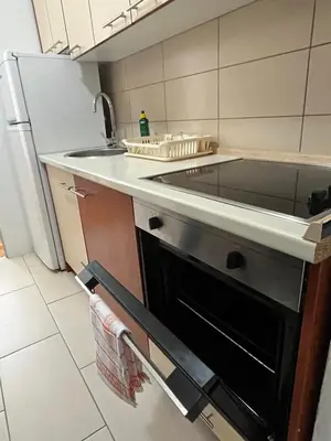 a kitchen with a stove top oven next to a refrigerator at Apartman Filip in Jajce