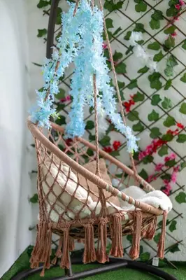 a wicker chair with blue flowers in it at Apartman D&A in Brekovica