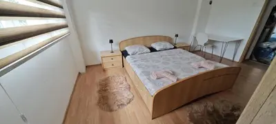 a small bedroom with a bed and a desk at Apartman D&A in Brekovica