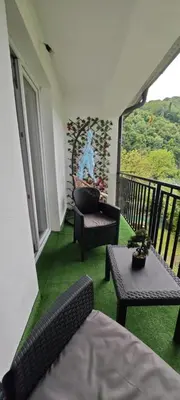 a room with a balcony with chairs and a table at Apartman D&A in Brekovica