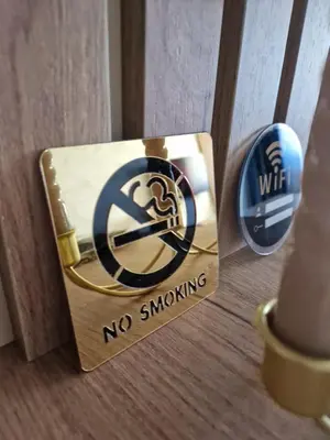 a box with a no smoking sign on a door at Apartman Eden in Doboj