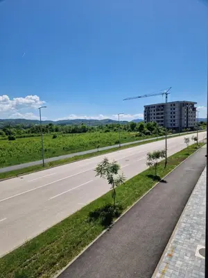 an empty highway with trees on the side at Apartman Eden in Doboj