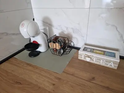 a table with a blender and a basket of cookies at Apartman Eden in Doboj