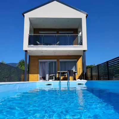 a house with a swimming pool in front of a house at Villa Alisa in Bihać
