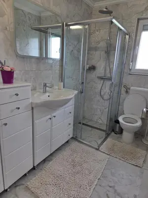 a bathroom with a shower and a sink and a toilet at Villa Alisa in Bihać