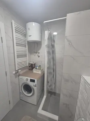 a small bathroom with a washing machine in it at Apartman Centar 8 Doboj in Doboj
