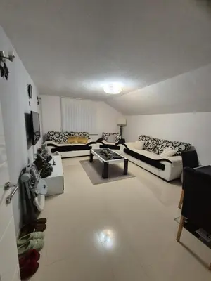 a large living room with two couches and a tv at Apartman IN in Bihać
