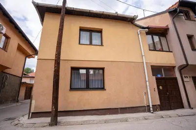 a building with a pole in front of it at Apartman Elyca in Visoko