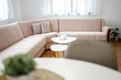 a living room with a couch and a table at Apartman Elyca in Visoko