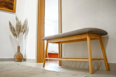 a stool with a cushion on it in a room at Apartman Elyca in Visoko