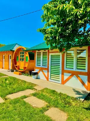 a building with green shutters on the side of it at Nedzad Barrel Apartments in Visoko
