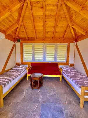a room with two beds and a table at Nedzad Barrel Apartments in Visoko