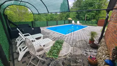 a patio with chairs and a swimming pool at Vikendica Mala Priča in Srebrenik