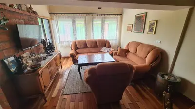 a living room with two leather chairs and a table at Vikendica Mala Priča in Srebrenik