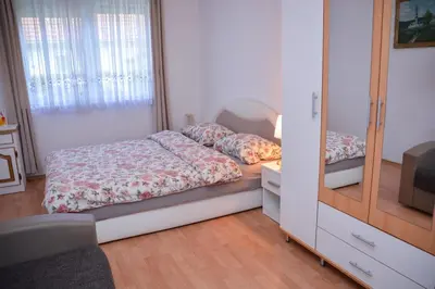 a small bedroom with a bed and a mirror at A Cozy Nest in Teslic in Teslić