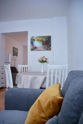 a living room with a blue couch and a table at A Cozy Nest in Teslic in Teslić