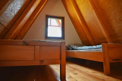 a room with two bunk beds and a window at Bungalovi Potočarska panorama in Mrkonjić Grad