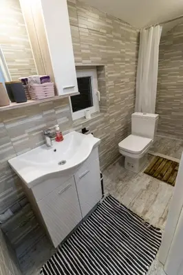 a bathroom with a white sink and a toilet at Guest House Lejla 2 in Travnik