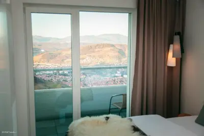 a room with a window with a view of a city at HOTEL Pyramid Lodge in Visoko