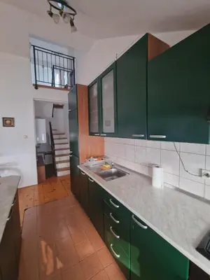 a kitchen with green cabinets and a sink at Apartman Sofija 2 in Banja Luka