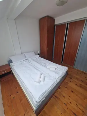 a bed with white sheets and white towels on it at Apartman Sofija 2 in Banja Luka