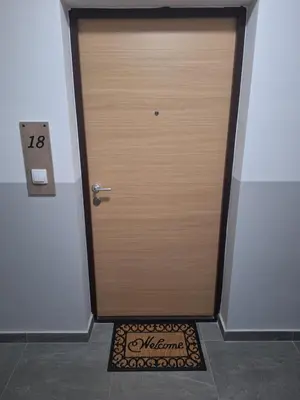 a wooden door with a sign in front of it at Apartman L&S in Doboj