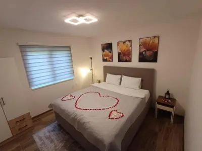 a bedroom with a bed with a heart drawn on it at Holiday Residence Šehić in Visoko