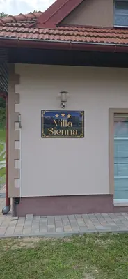 a sign on the side of a house at Villa Sienna in Smrdan