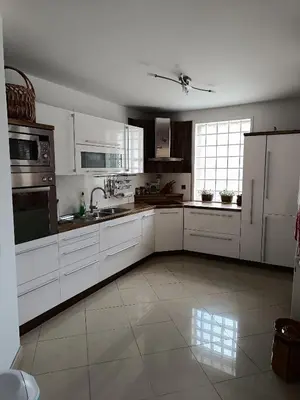 a large kitchen with white cabinets and appliances at Villa Sienna in Smrdan