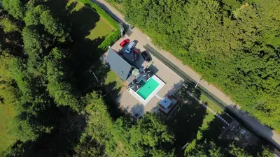 an overhead view of a truck parked on a road next to a field at Vikendica Sofijina Luka in Slatina Varoš