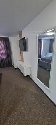 a room with a bedroom with a mirror and a bed at Apartmani EŠ in Ivišovo Greblje