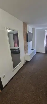 an empty room with a tv and a window at Apartmani EŠ in Ivišovo Greblje