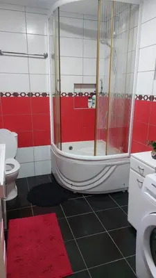 a bathroom with a shower and a tub and a toilet at Gajic & Milini in Banja Luka