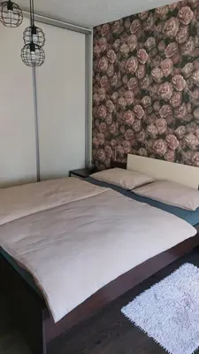 a bedroom with a large bed with a wall with flowers at Gajic & Milini in Banja Luka